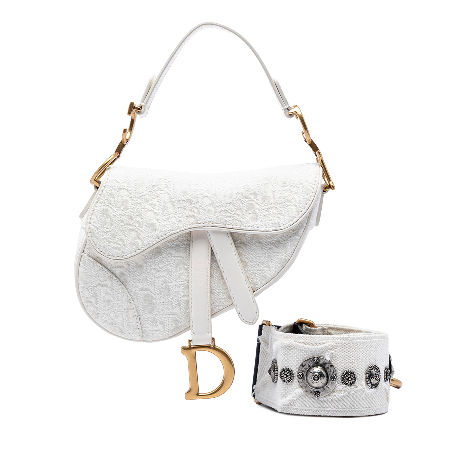 Dior Saddle Mini Bag in Oblique Embroidered Canvas: Dior Saddle Mini Bag in Oblique Embroidered Canvas Mini Saddle bag in white embroidered canvas with leather trim. It features a flat leather strap, a detachable flat strap, a front flap with magnetic 