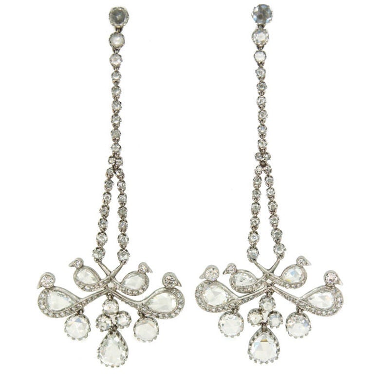 Platinum Bird Form Chandelier Earrings with Rose Cut Diamonds: Platinum Bird Form Chandelier Earrings with Rose Cut Diamonds Platinum chandelier earrings featuring rose cut diamonds and a stylized bird design. The earrings were made in the United Kingdom during t