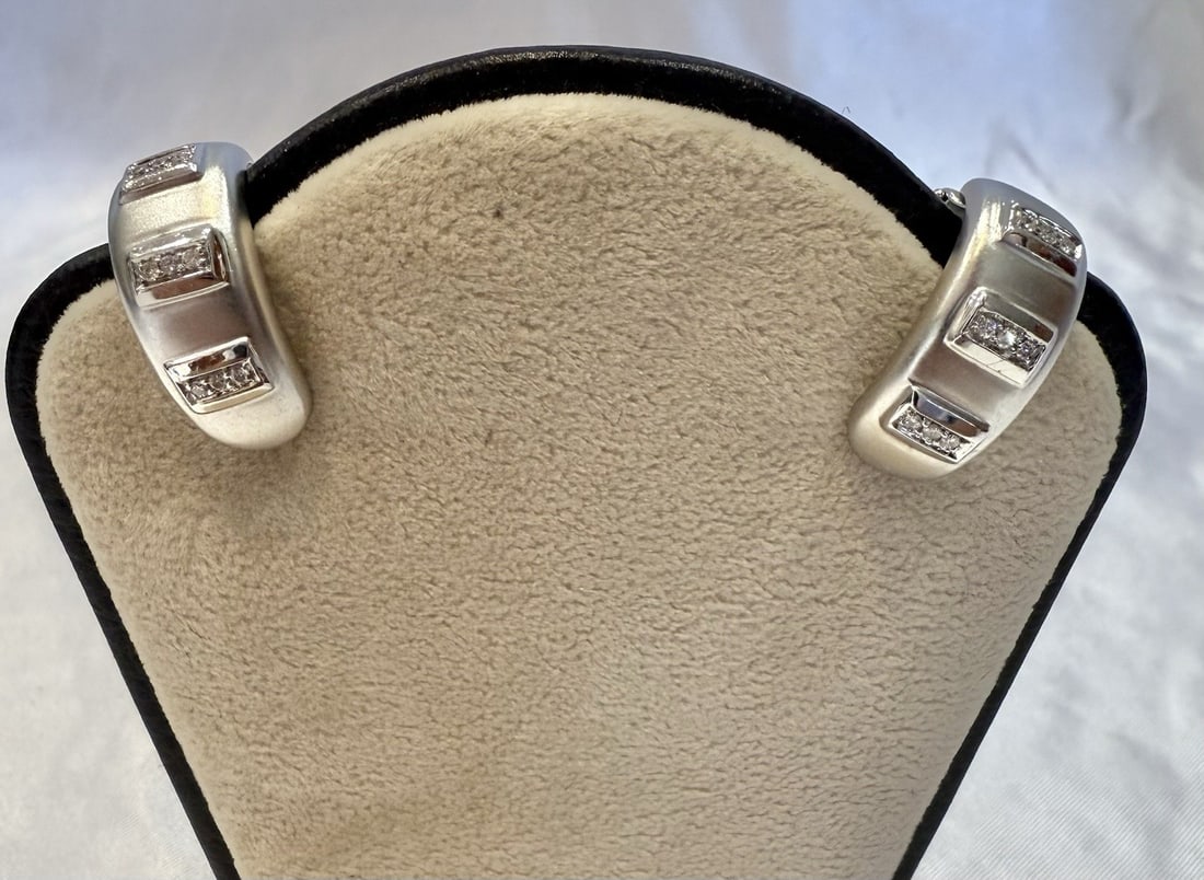 18K White Gold Cuff Earrings with 0.15ct Diamonds: 18K White Gold Cuff Earrings with 0.15ct Diamonds This stunning pair of earrings features a sophisticated design crafted from 18K white gold. Each earring showcases exquisite detail and craftsmanship,