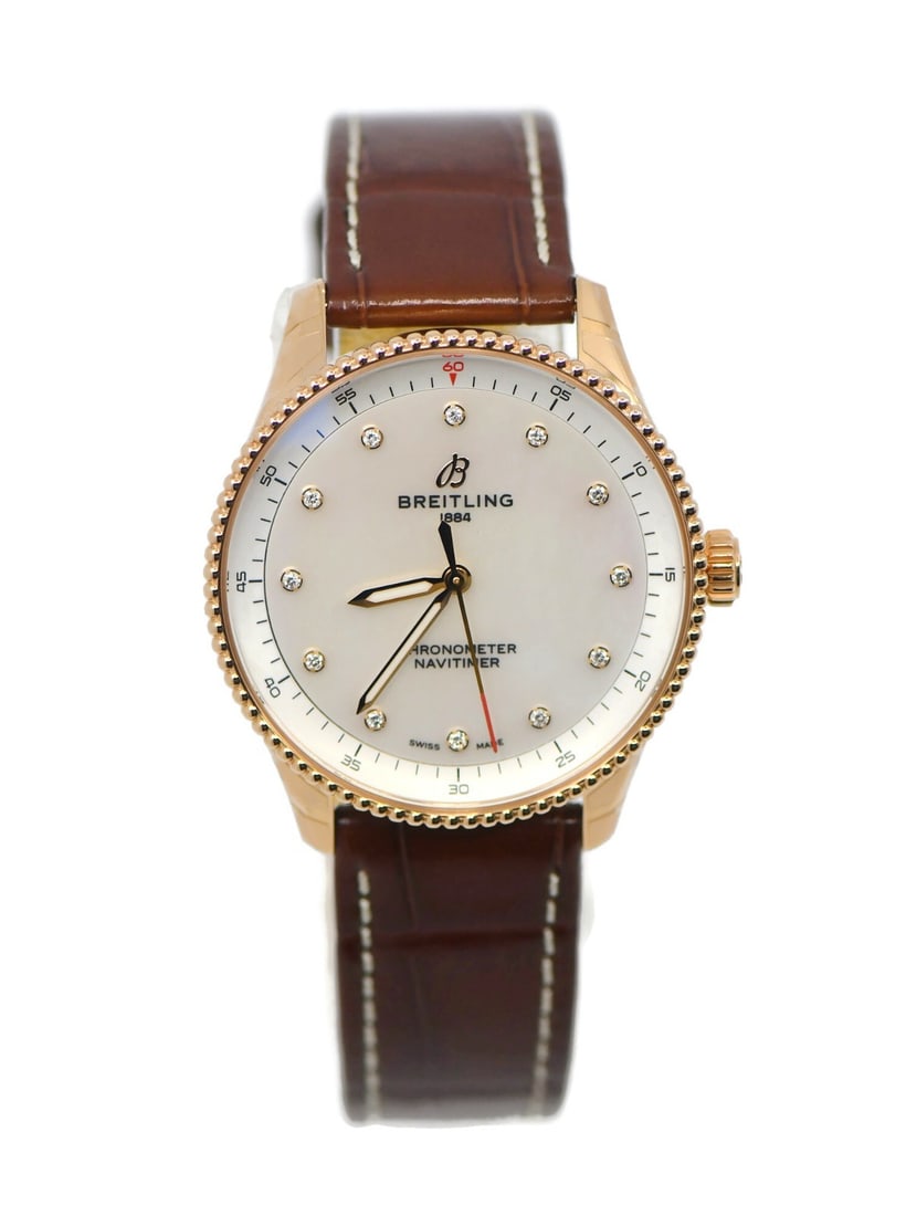 Breitling Navitimer 18K Rose Gold Quartz Women's Wristwatch: Breitling Navitimer 18K Rose Gold Quartz Women's Wristwatch This Breitling Navitimer wristwatch features a 32mm case crafted from 18K rose gold, complemented by a rose gold bezel. The watch is powered