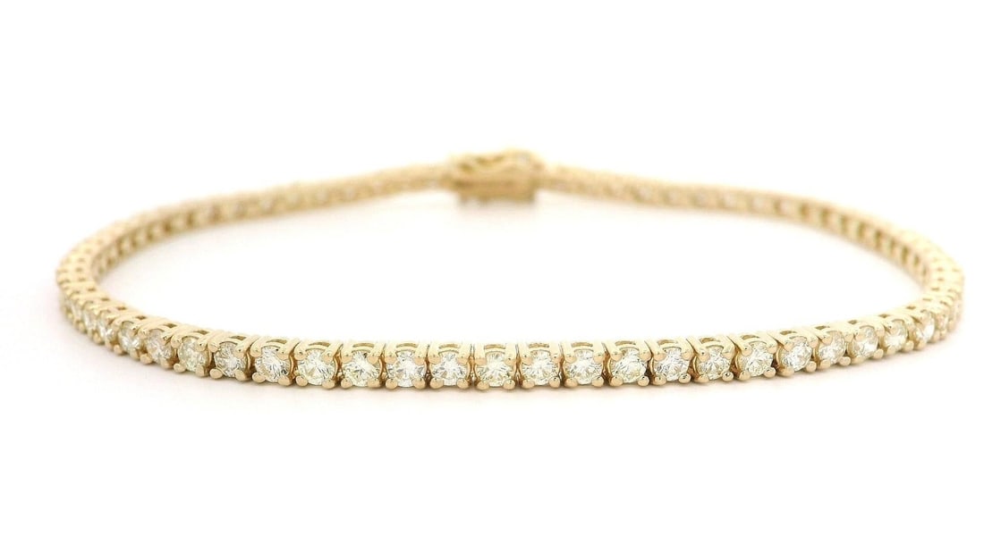 14k Yellow Gold 2.65ctw Round Diamond Tennis Bracelet: 14k Yellow Gold 2.65ctw Round Diamond Tennis Bracelet This exquisite tennis bracelet showcases a stunning array of 68 natural, round brilliant cut diamonds, prong set for maximum sparkle. The diamonds