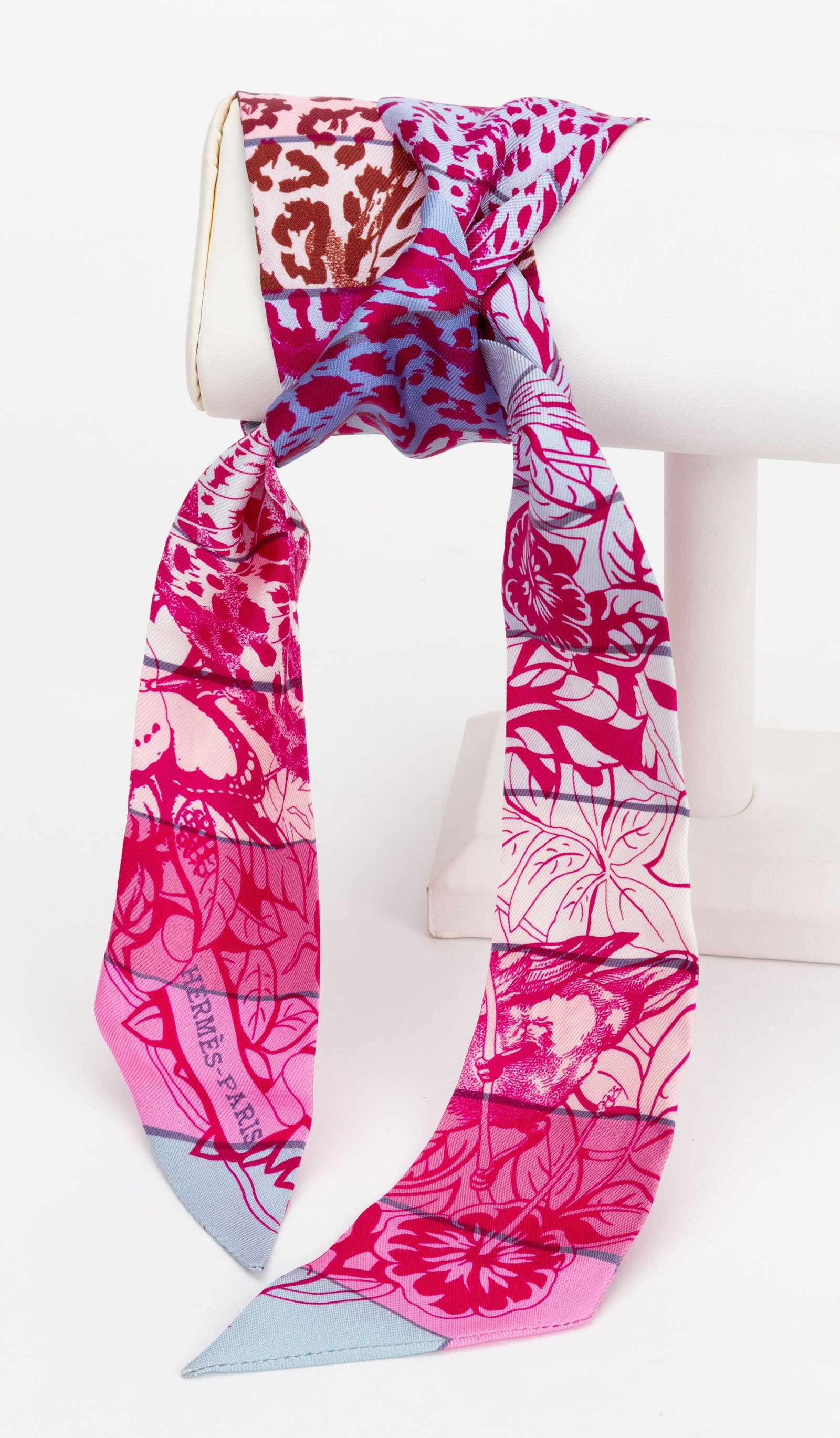 Hermes Ghepard Twilly Scarf Pink Print with Box: Hermes Ghepard Twilly Scarf Pink Print with Box Hermes "Ghepard" Twilly scarf featuring a pink print design and silver tone hardware. Comes in box. Condition is un-used. Specifications Brand: Hermes I