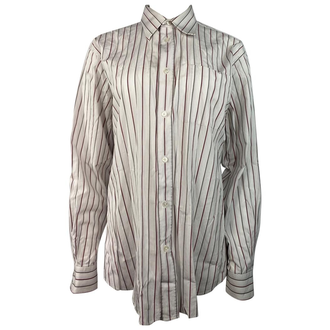 Hermes 42 White Cotton Button Down Shirt Striped: Hermes 42 White Cotton Button Down Shirt Striped A formal Hermes button-down shirt in white 100% cotton with a thin striped pattern in green, purple, and red. Made in France, it is marked size 42 (EU)