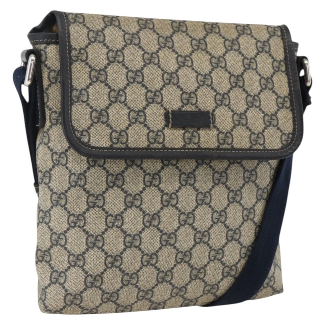 Navy GG Canvas Flap Messenger Bag by Gucci Unisex: Navy GG Canvas Flap Messenger Bag by Gucci Unisex This Gucci Flap Messenger bag features GG coated canvas in navy. Designed for unisex use, it offers a practical flap closure and an adjustable shoulde