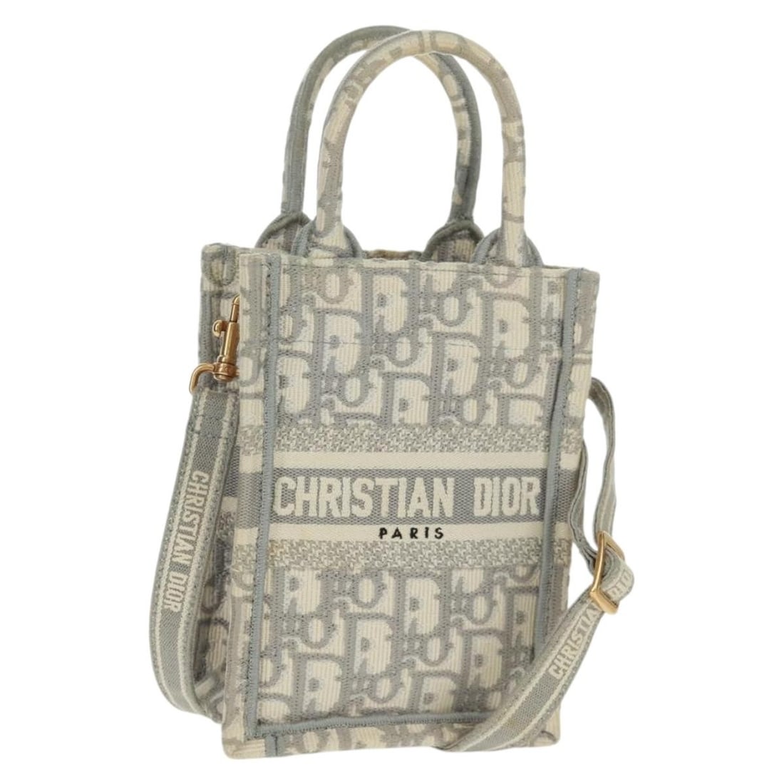 Mini Book Tote Handbag in White Gold Trotter Canvas by Christian Dior: Mini Book Tote Handbag in White Gold Trotter Canvas by Christian Dior This Christian Dior Trotter Canvas Oblique Book Tote Mini Bag showcases a white and gold colorway with the iconic Dior Trotter can