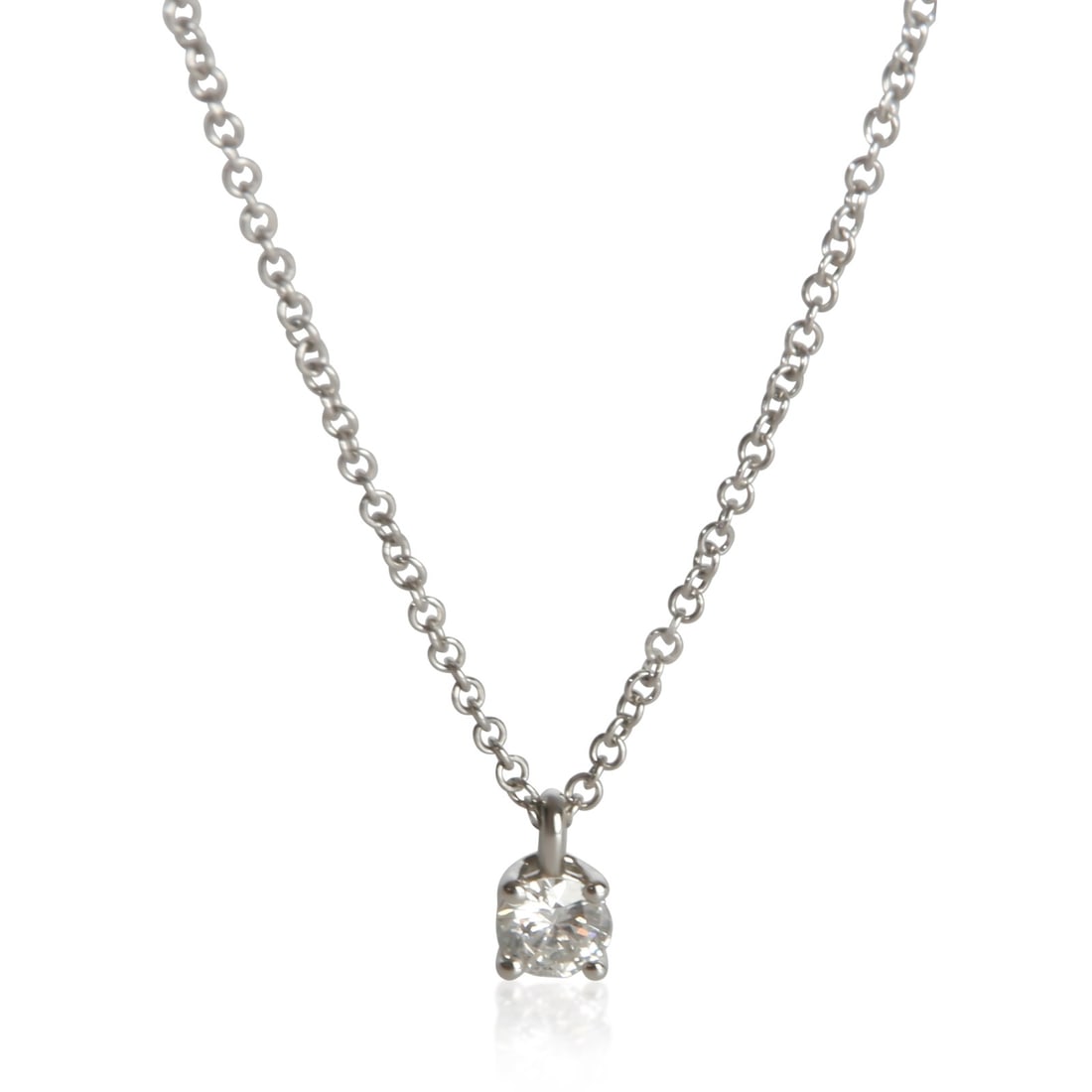 Tiffany Co Solitaire Diamond Pendant in Platinum with Box Papers: Tiffany Co Solitaire Diamond Pendant in Platinum with Box Papers Tiffany & Co. solitaire pendant from the Women's collection, featuring a round brilliant diamond design in platinum. This pre-owned pen