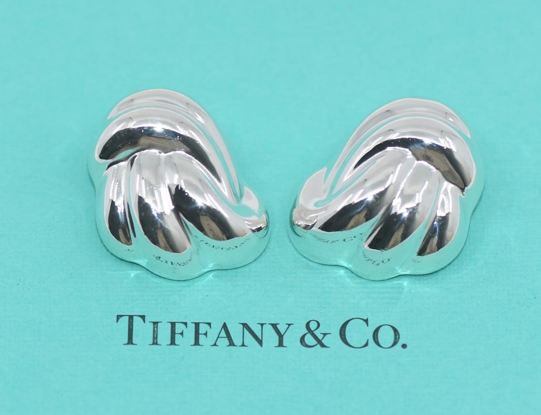 Tiffany & Co Authentic Sterling Silver Stud Earrings 30x24mm: Tiffany & Co Authentic Sterling Silver Stud Earrings 30x24mm Elevate your accessory collection with these authentic Tiffany & Co. sterling silver earrings. Designed as elegant stud earrings, they feat