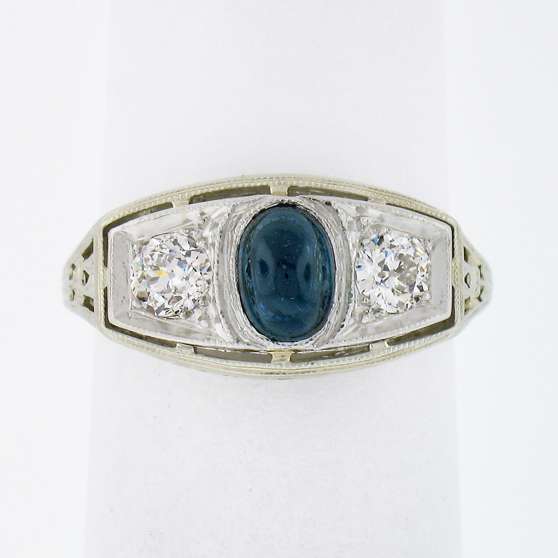 Art Deco 3 Stone Ring 18k White Gold Platinum Sapphire Diamond Filigree: Art Deco 3 Stone Ring 18k White Gold Platinum Sapphire Diamond Filigree Antique Art Deco three-stone band ring featuring a cabochon sapphire center accented by two old European cut diamonds. The ring 