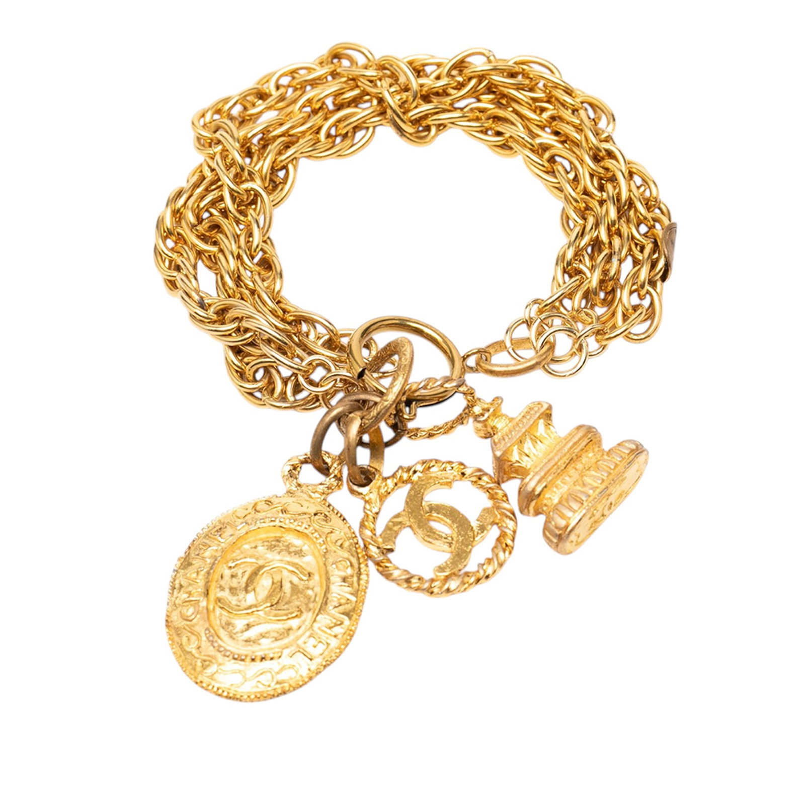 Chanel CC triple chain charm bracelet in gold plated metal: Chanel CC triple chain charm bracelet in gold plated metal Gold-plated Chanel triple-chain bracelet with CC logo charm embellishment and additional charms. This costume jewelry piece is made in France