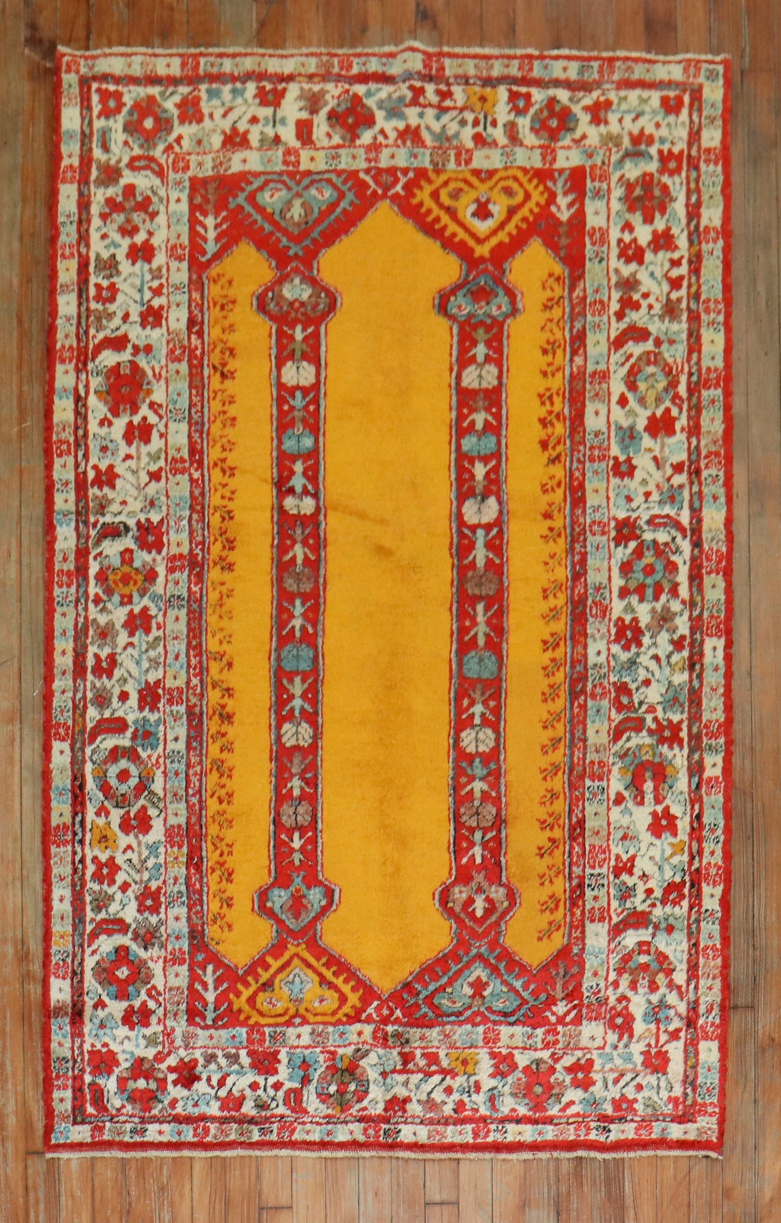 3' 11" x 6' Antique Angora Wool Prayer Rug Oushak: 3' 11" x 6' Antique Angora Wool Prayer Rug Oushak Early 20th century antique Oushak accent rug woven from angora goat wool. It features a bright saffron field with a double scroll column prayer motif.