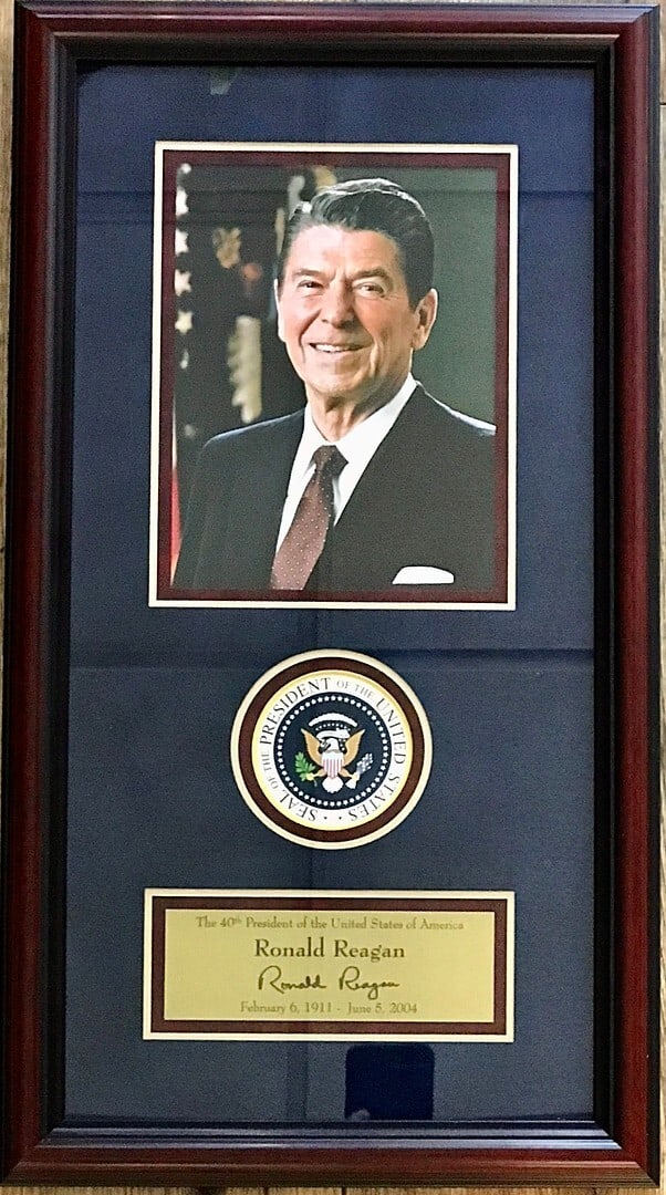 Ronald Reagan 1985 Photo Display with Laser Engraved Signature Custom Framed: Ronald Reagan 1985 Photo Display with Laser Engraved Signature Custom Framed This custom framed display features a laser engraved facsimile signature of President Ronald Reagan, set against a stunning