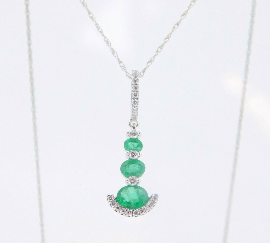 Stunning 14k White Gold Pendant with .54ct Emeralds and .11ct Diamonds: Stunning 14k White Gold Pendant with .54ct Emeralds and .11ct Diamonds This exquisite 14k white gold pendant showcases genuine natural emeralds totaling .54ct and .11ct diamonds, making it a stunning 