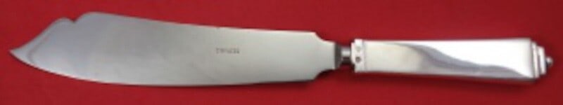 Georg Jensen Pyramid Sterling Silver Cake Knife 10 1/8": Georg Jensen Pyramid Sterling Silver Cake Knife 10 1/8" Discover the elegant Pyramid cake knife by Georg Jensen, a stunning addition to any dining experience. This exquisite piece features a sterling 
