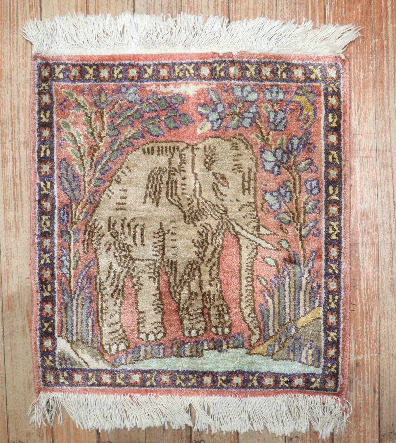 1' 3" x 1' 4" Turkish pictorial square yastik rug with elephant: 1' 3" x 1' 4" Turkish pictorial square yastik rug with elephant Late 20th century Turkish pictorial rug featuring an elephant motif on a pink field with surrounding floral elements. This pre-owned squ