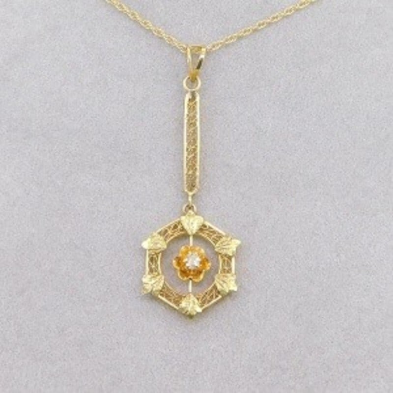 Victorian 14k Yellow Gold Diamond Lavaliere Pendant with Green Gold Accents: Victorian 14k Yellow Gold Diamond Lavaliere Pendant with Green Gold Accents Discover the elegance of this authentic Victorian lavaliere pendant crafted in 14k yellow gold. This exquisite piece feature