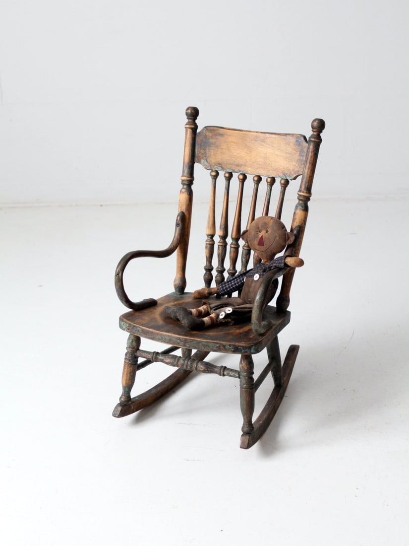 Vintage Wooden Children's Rocking Chair with Spindle Back: Vintage Wooden Children's Rocking Chair with Spindle Back This antique children's rocking chair is a charming piece that adds character to any space. Crafted from wood, it features a beautifully turne