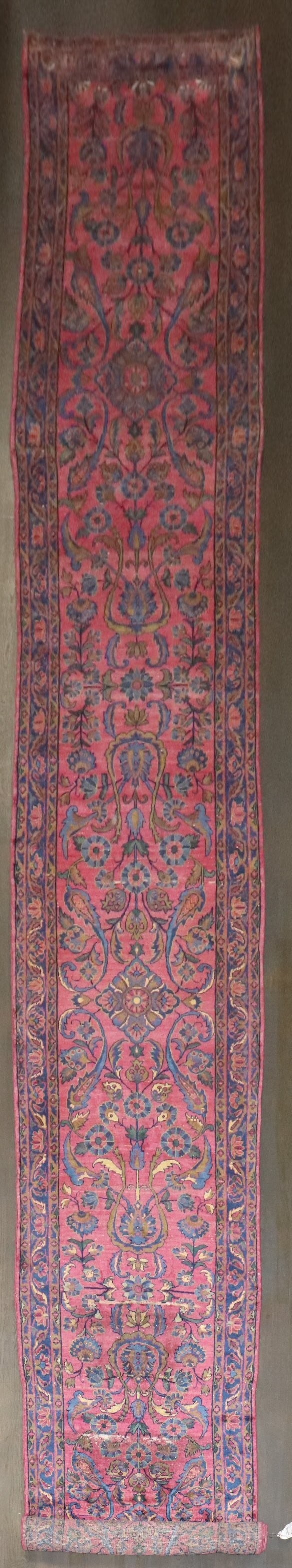 2' 9" x 21' 3" Antique Indian Kashan Rug Runner: 2' 9" x 21' 3" Antique Indian Kashan Rug Runner Early 20th century Indo Kashan runner featuring rich plum, green, and magenta tones. This pre-owned rug shows areas of wear in the middle, with an other
