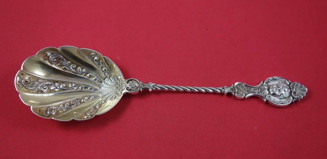 Goldsmith & Silversmith Co. Sterling Silver Figural Berry Spoon 8 3/8": Goldsmith & Silversmith Co. Sterling Silver Figural Berry Spoon 8 3/8" This exquisite sterling silver berry spoon, crafted by Goldsmith & Silversmith Co., features a beautifully figural handle that is