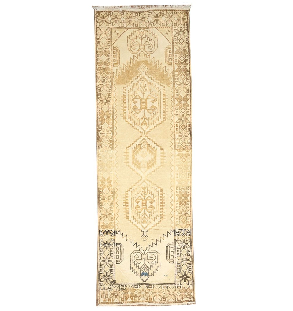 Hand Knotted Wool Tribal Runner Rug 3'2 x 10'0 Muted Vintage: Hand Knotted Wool Tribal Runner Rug 3'2 x 10'0 Muted Vintage This semi-antique handmade tribal runner rug features a muted color palette, including shades of golden cream, brown, and blue. Expertly ha