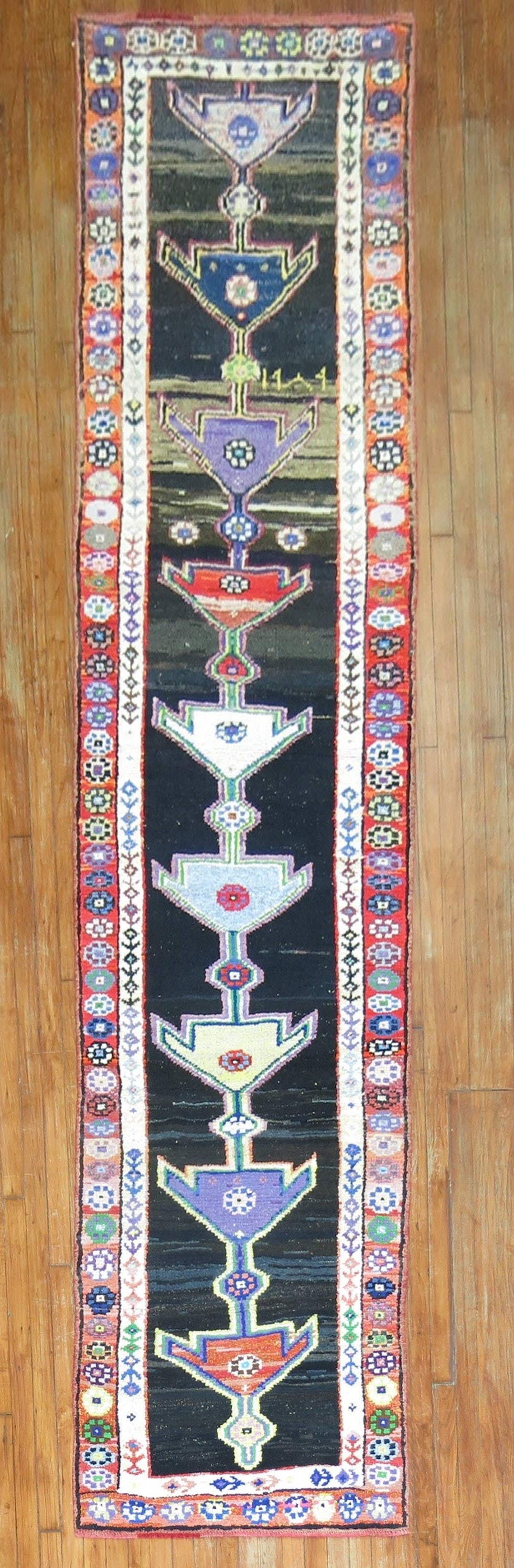 2' 10" x 12' 9" Geometric Turkish Anatolian Rug Runner: 2' 10" x 12' 9" Geometric Turkish Anatolian Rug Runner Mid 20th century Turkish Anatolian runner with a geometric design and vibrant stylized motifs. This pre-owned rug has a long, narrow runner forma