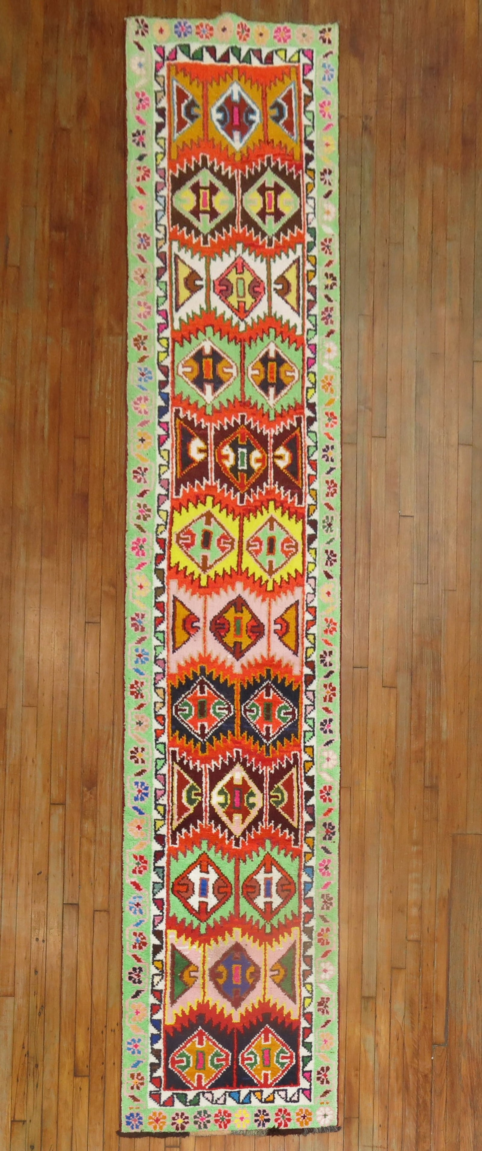 2' 9" x 13' 2" Turkish Anatolian Runner Multicolored Rug: 2' 9" x 13' 2" Turkish Anatolian Runner Multicolored Rug Long and narrow Turkish Anatolian runner from the 3rd quarter of the 20th century, featuring an eclectic design with a flashy array of electric