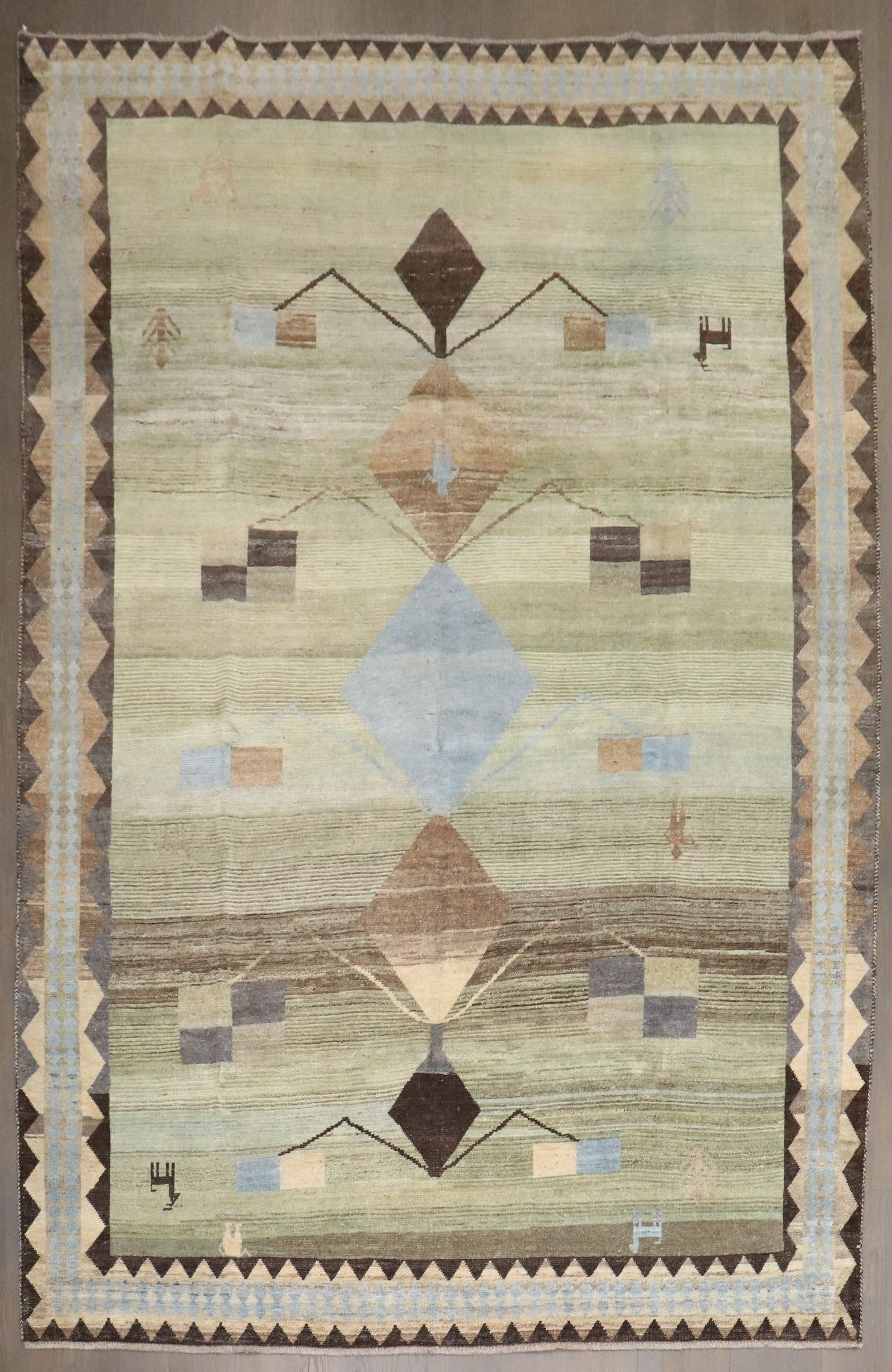 6' 10" x 9' 10" Persian Gabbeh Rug Geometric Design: 6' 10" x 9' 10" Persian Gabbeh Rug Geometric Design Mid-20th-century Persian Gabbeh rug featuring a geometric design in earthy blue, brown, and green tones. This pre-owned carpet offers the character 