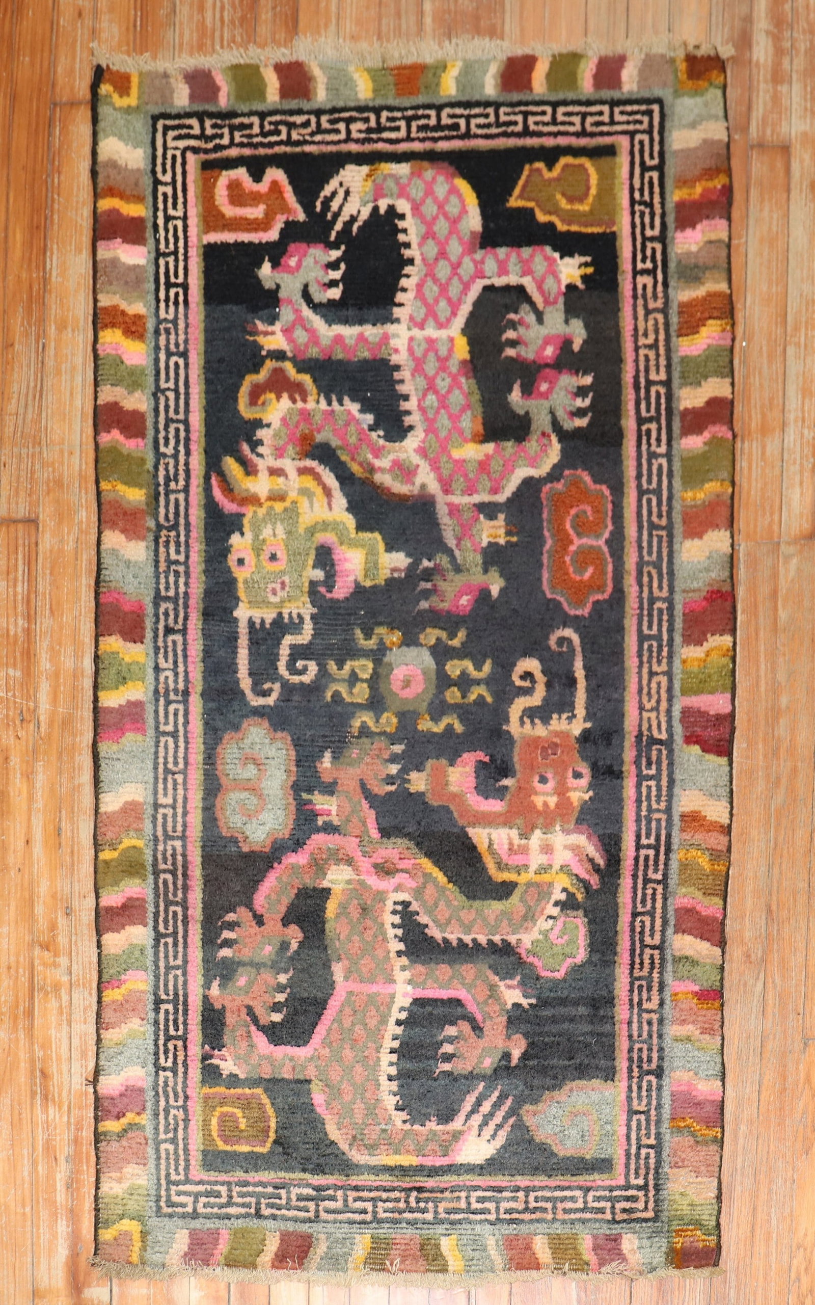2' 9" x 5' 1" Pictorial Tibetan Rug with Dragon Motif: 2' 9" x 5' 1" Pictorial Tibetan Rug with Dragon Motif A 1940s Tibetan pictorial rug featuring a dragon motif. This small pre-owned rug presents a distinctive decorative design consistent with Tibetan 