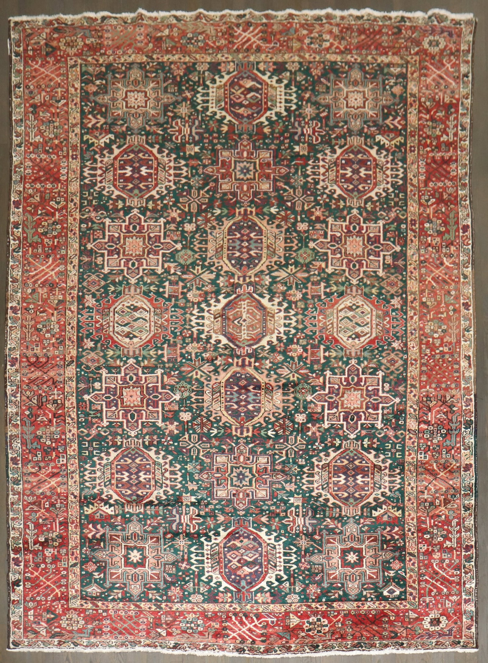 7' 9" x 10' 11" Mid Century Persian Serapi Heriz Rug: 7' 9" x 10' 11" Mid Century Persian Serapi Heriz Rug Mid-20th-century Persian Heriz rug with a green field and geometric design. This pre-owned room-size rug is identified as a Serapi/Heriz type. Spec