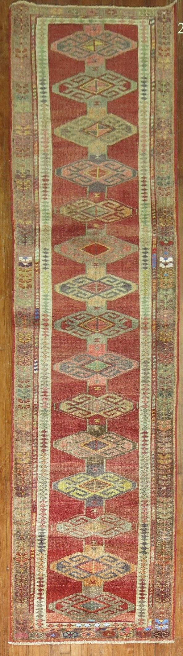 2' 11" x 11' 1" Mid 20th Century Anatolian Kurd Turkish Runner: 2' 11" x 11' 1" Mid 20th Century Anatolian Kurd Turkish Runner Mid-20th century Turkish Anatolian Kurd runner with geometric patterning in red, cream, and earthy tones. This pre-owned runner reflects 