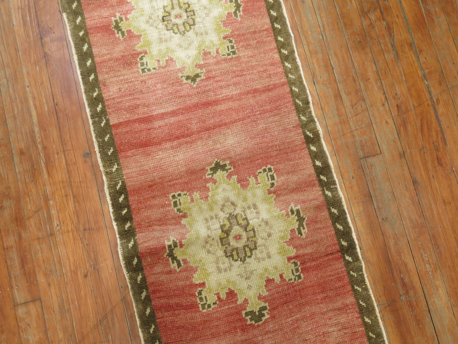 1' 10" x 9' 8" Turkish Konya runner red pink abrashed: 1' 10" x 9' 8" Turkish Konya runner red pink abrashed Vintage Turkish Konya runner from the mid-20th century, featuring five medallions on a soft red and pink abrashed ground. This pre-owned runner of