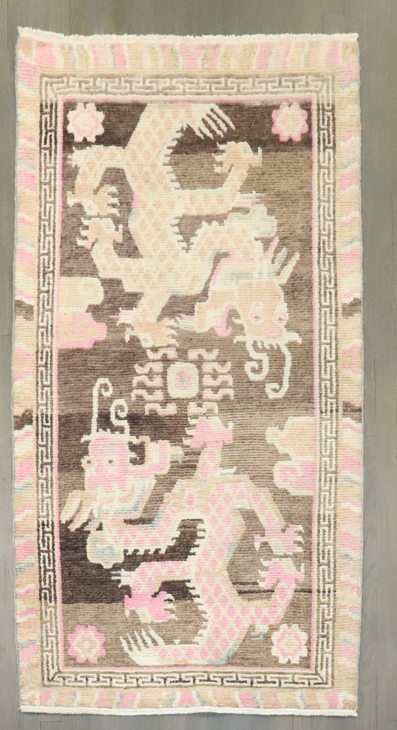 3' 1" x 5' 7" Pictorial Tibetan Dragon Rug: 3' 1" x 5' 7" Pictorial Tibetan Dragon Rug Mid 20th century Tibetan pictorial rug with a dragon motif. This pre-owned rectangular rug features a decorative design in a small format. Specifications Tit