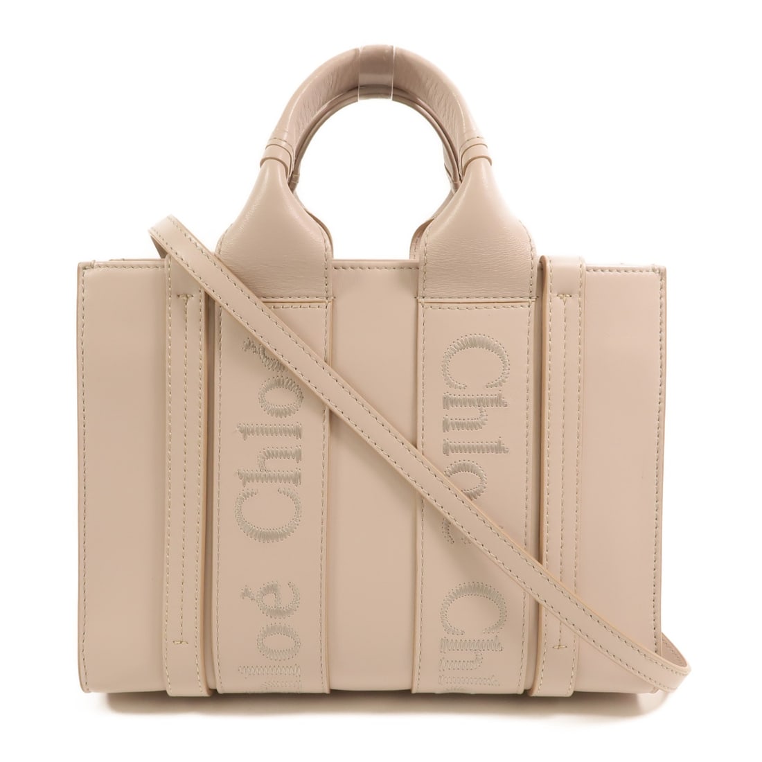 Chloe Woody Small Calfskin 2 Way Shoulder Bag Beige: Chloe Woody Small Calfskin 2 Way Shoulder Bag Beige Chloe Woody Small 2 Way Shoulder Bag in beige calfskin leather. This women's bag features a structured silhouette with top handles and an adjustable