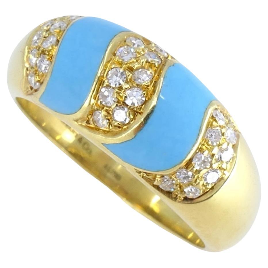 Tiffany & Co. 1960s 18k Gold Ring with Turquoise and Diamonds: Tiffany & Co. 1960s 18k Gold Ring with Turquoise and Diamonds A classic 1960s ring with a textured 18k yellow gold band, featuring double vivid blue turquoise S-shaped bands accented by brilliant-cut 
