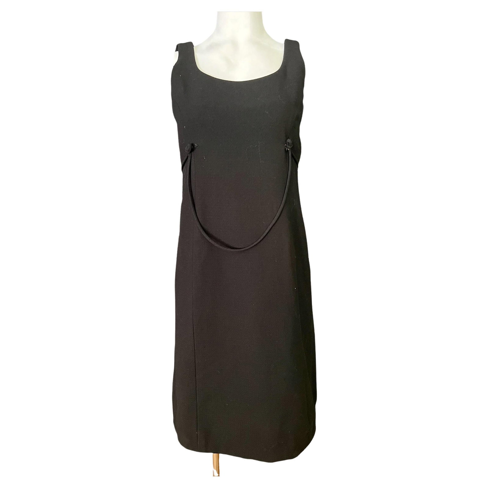 Black belted knee length dress by Geoffrey Beene for Saks Fifth Avenue: Black belted knee length dress by Geoffrey Beene for Saks Fifth Avenue Black midi dress by Geoffrey Beene for Saks Fifth Avenue, featuring a sleeveless design, knee-length cut, belted detail with knot