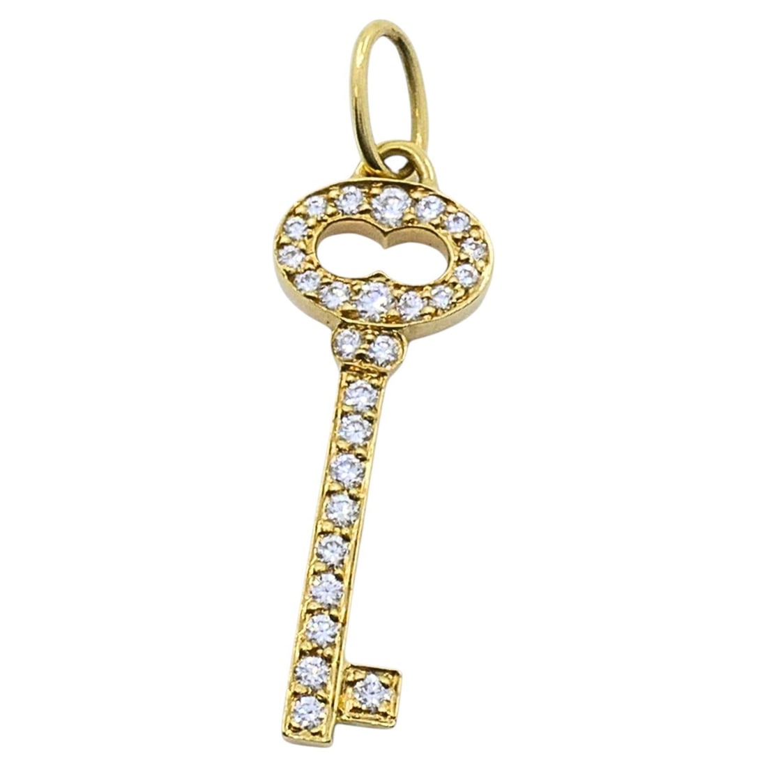 Tiffany Co Keys diamond pendant in 18k yellow gold: Tiffany Co Keys diamond pendant in 18k yellow gold Tiffany & Co. 18k yellow gold key pendant set with round diamonds. The piece is from the 21st century, circa 2000s, and comes with the original Tiffa
