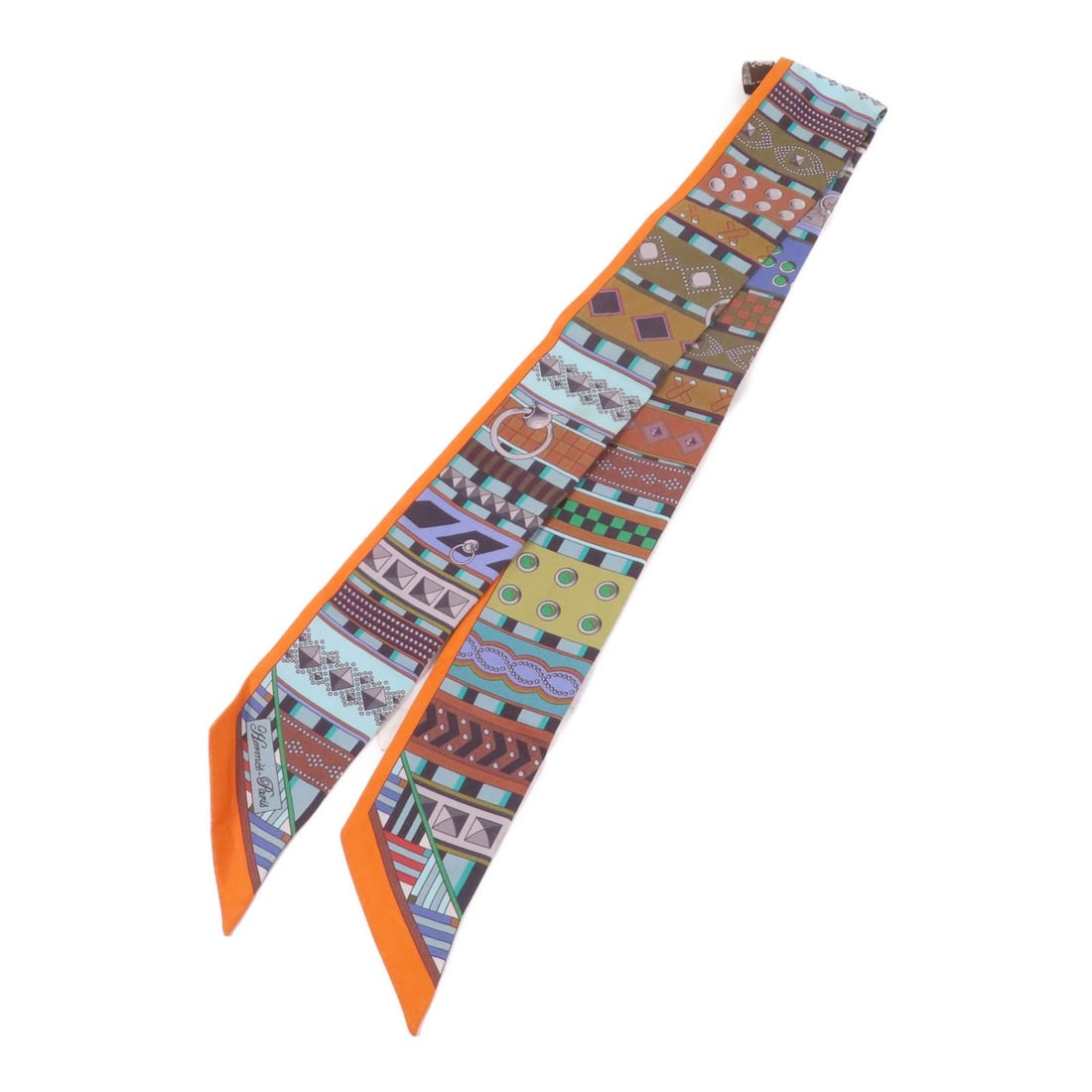 Hermes Twilly Silk Scarf Multicolor Made in France: Hermes Twilly Silk Scarf Multicolor Made in France Hermes Twilly scarf in silk with a multicolor and orange colorway. It is a women's regular-size scarf made in France and is offered in very good AB c