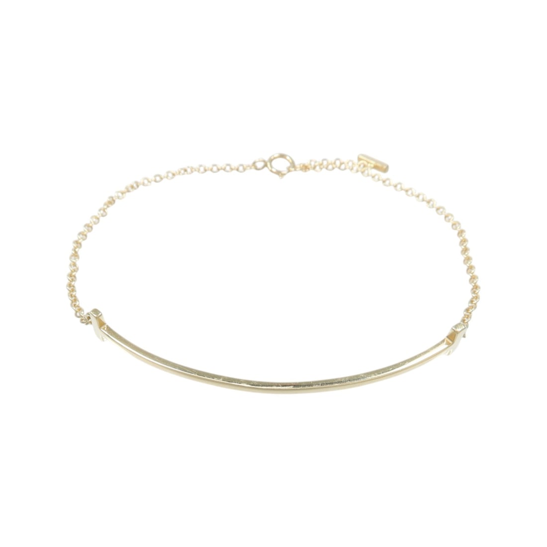 Tiffany and Co T Smile 18K Yellow Gold Bracelet: Tiffany and Co T Smile 18K Yellow Gold Bracelet Tiffany & Co. T Smile bracelet in 18K yellow gold with a sleek, stone-free design. Includes storage box and case. Condition is AB: Very Good. Specificat
