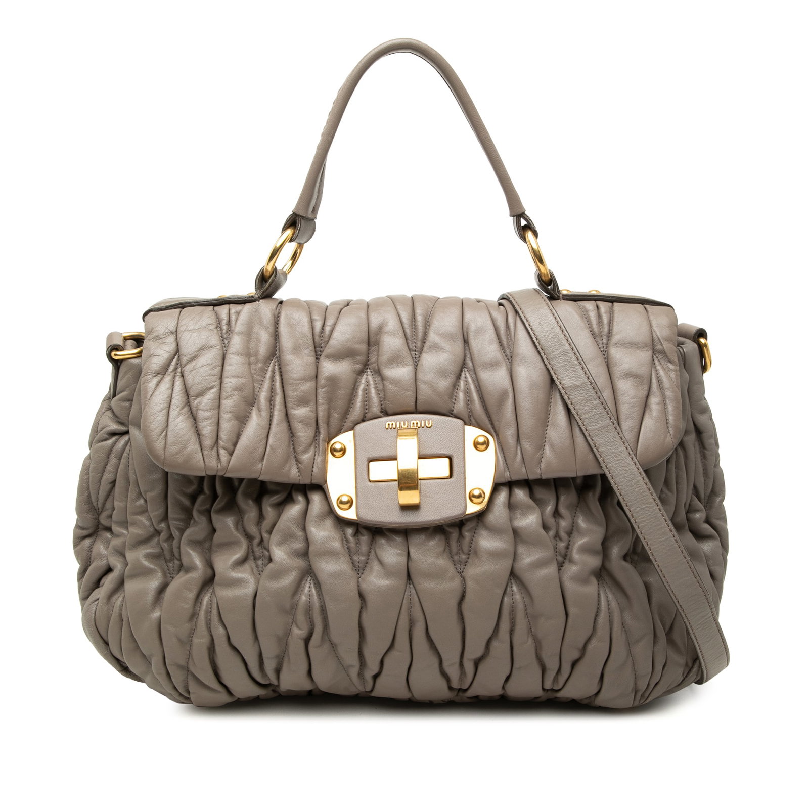 Miu Miu Matelasse Brown Nappa Leather Satchel Bag: Miu Miu Matelasse Brown Nappa Leather Satchel Bag Miu Miu Matelasse Nappa Satchel in brown leather with a pleated body, flat leather handle, and detachable flat strap. The satchel features a front fla