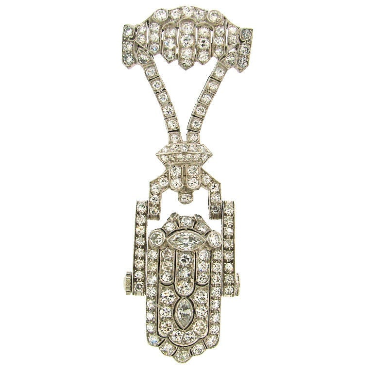 French Art Deco Platinum Diamond Lapel Watch Glycine Movement: French Art Deco Platinum Diamond Lapel Watch Glycine Movement Elegant Art Deco lapel watch created in France circa the 1920s, featuring a platinum case with meticulous engraving and a tasteful combina