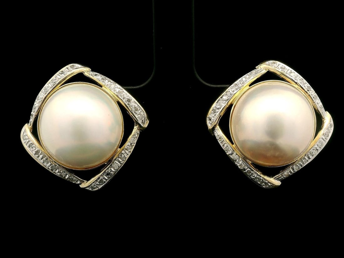 Omega 14k Yellow Gold Mabe Pearl Diamond Button Earrings: Omega 14k Yellow Gold Mabe Pearl Diamond Button Earrings Elevate your elegance with these stunning 14k Yellow Gold Large Mabe Pearl & Diamond Lozenge Button Omega Back Earrings. Featuring two genuine 