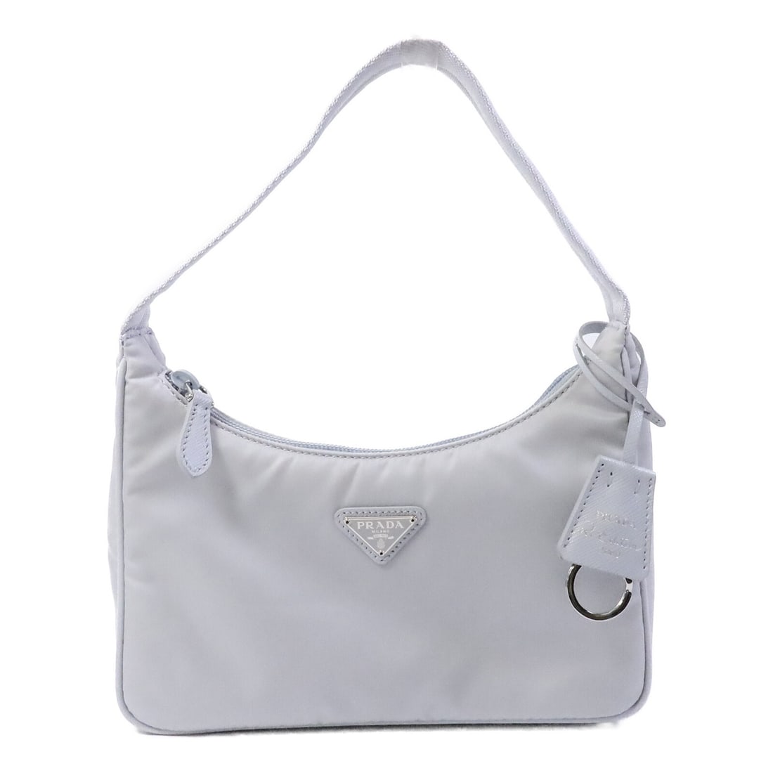 PRADA Re-Edition 2000 1NE515 Mini Shoulder Bag Blue Nylon: PRADA Re-Edition 2000 1NE515 Mini Shoulder Bag Blue Nylon A PRADA Re-Edition 2000 Mini Shoulder Bag in blue Fiordaliso grayish blue, made from nylon. This model is identified as 1NE515 and comes with 