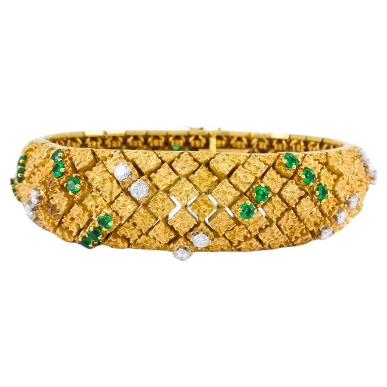 Vintage French Emerald Diamond Bracelet in 18k Gold and Platinum: Vintage French Emerald Diamond Bracelet in 18k Gold and Platinum Vintage French bracelet crafted in 18k yellow gold and platinum, accented with emeralds and diamonds. The band features a textured gold