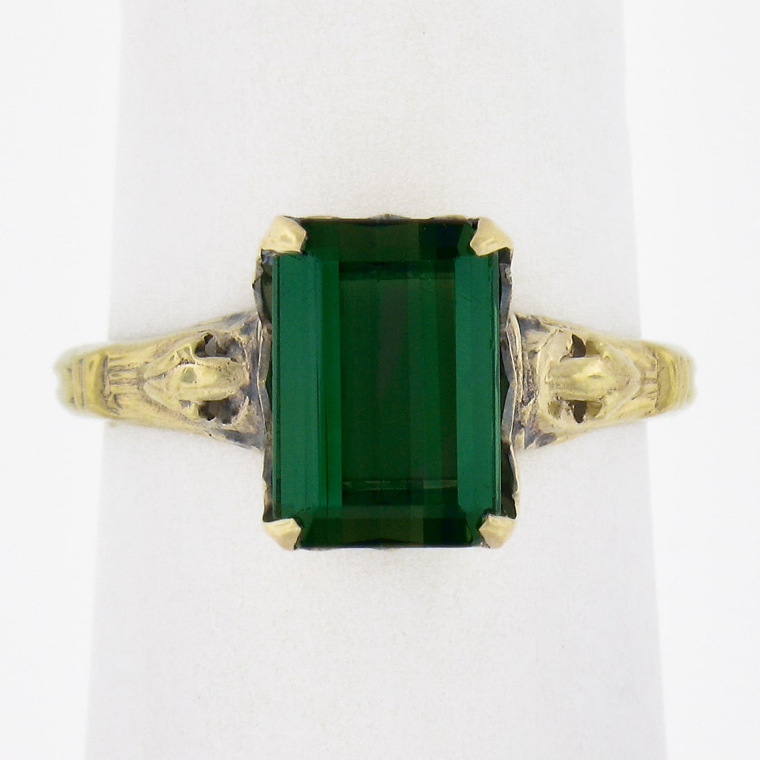 Unbranded 10K Yellow Gold Ring with 2.64ct Green Tourmaline: Unbranded 10K Yellow Gold Ring with 2.64ct Green Tourmaline Vintage solitaire band ring crafted in solid 10K yellow gold and set with one natural genuine green tourmaline in an emerald cut. The stone 