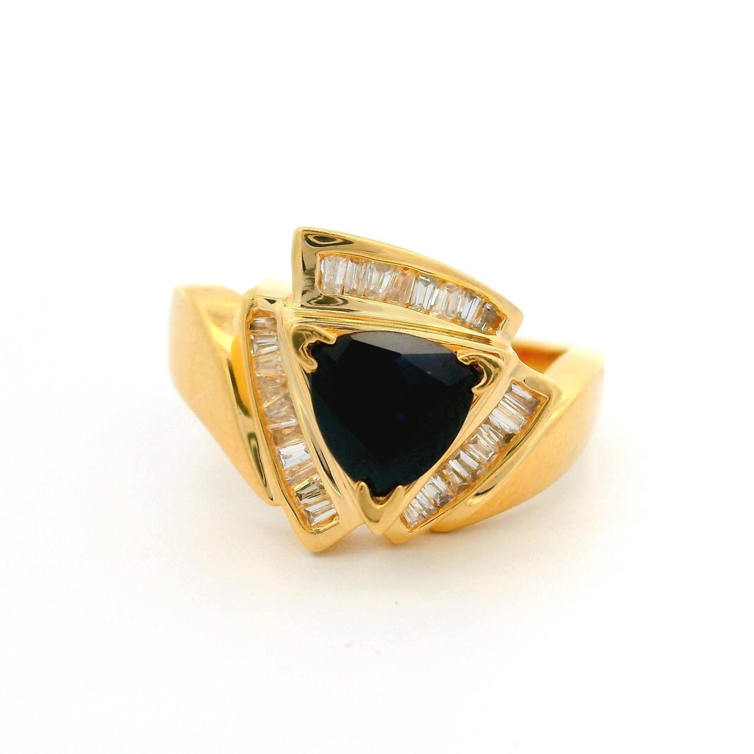 14k Yellow Gold Trillion Sapphire Ring with Baguette Diamond Accents: 14k Yellow Gold Trillion Sapphire Ring with Baguette Diamond Accents This stunning ring features a captivating trillion cut natural sapphire, securely prong set in a rich 14k yellow gold band. The dee