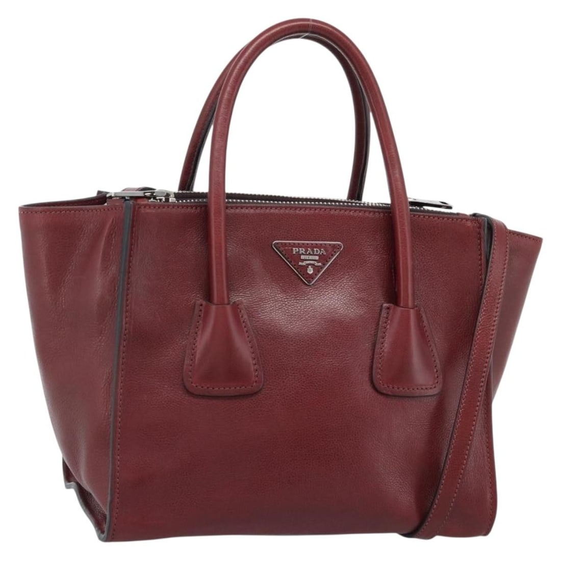Prada red leather 2 way handbag with shoulder strap silver tone: Prada red leather 2 way handbag with shoulder strap silver tone Authentic Prada 2-way handbag in red leather with silver-tone accents. Designed for women, this bag can be carried by the handles or wor
