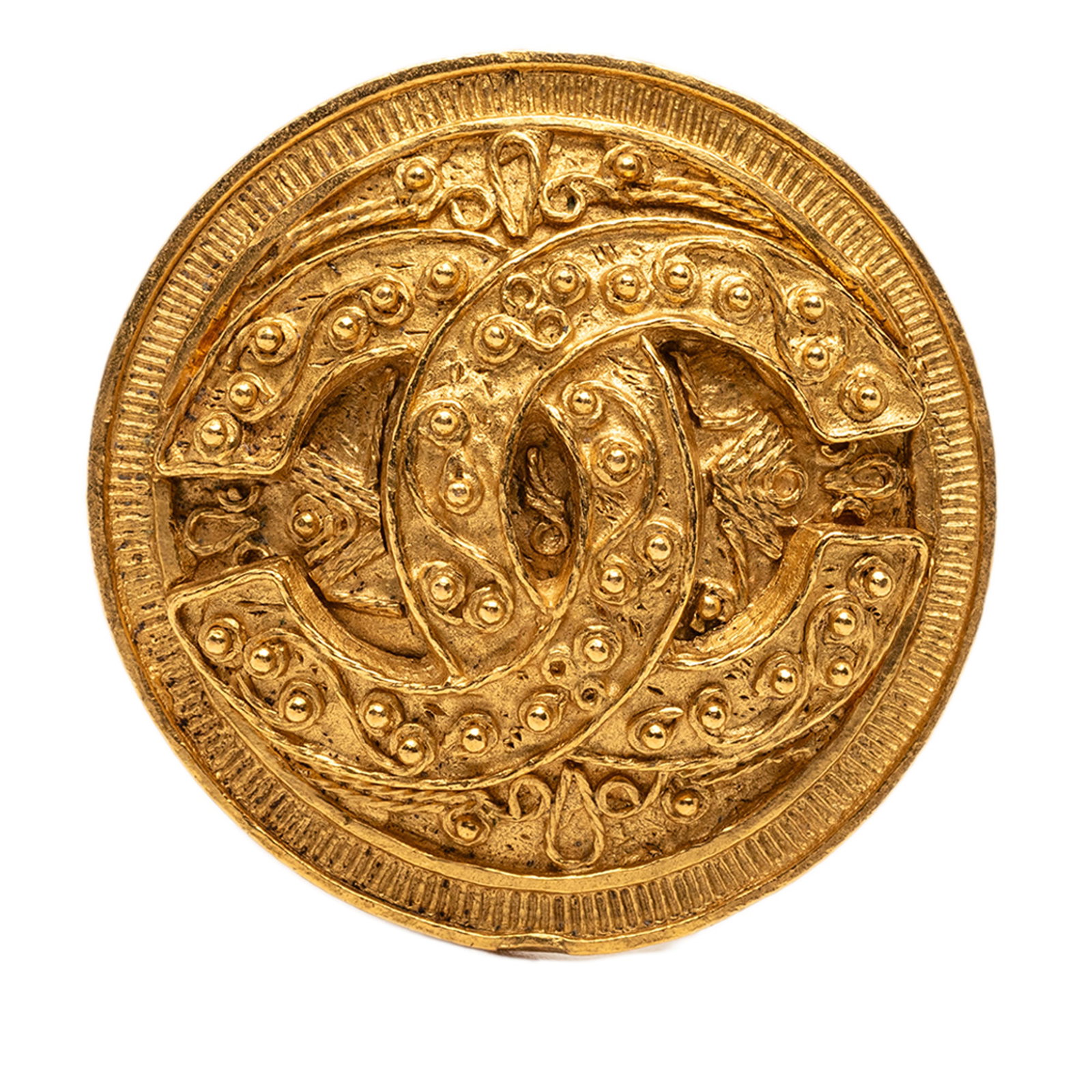 Chanel round CC brooch gold tone metal: Chanel round CC brooch gold tone metal This Chanel brooch features a gold tone metal body with a round design and a back pin closure. The brooch is categorized as costume jewelry and is crafted in Fra
