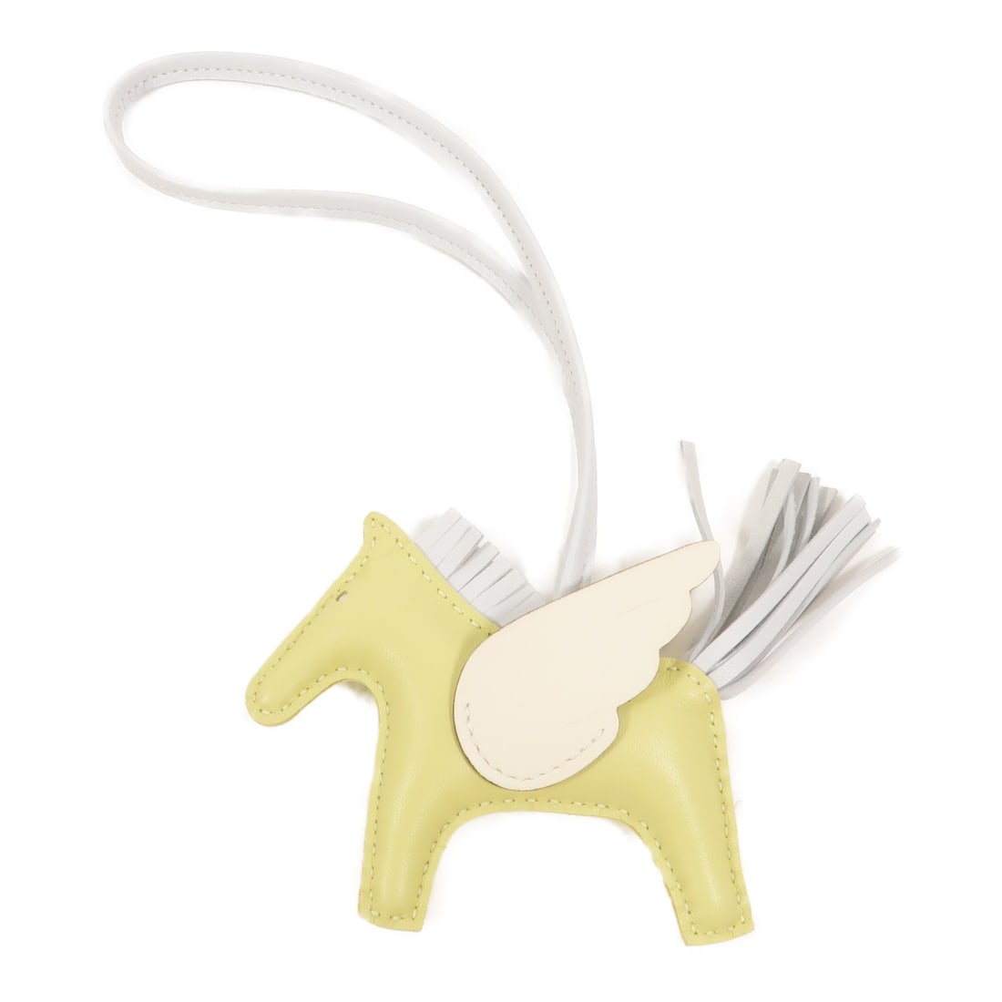 Hermes Rodeo Pegase PM lambskin charm Vert Criquet Nata: Hermes Rodeo Pegase PM lambskin charm Vert Criquet Nata Hermes Rodeo Pegase PM charm crafted in Agneau Milo lambskin in Vert Criquet and Nata. This unisex charm is made in France and includes its stor