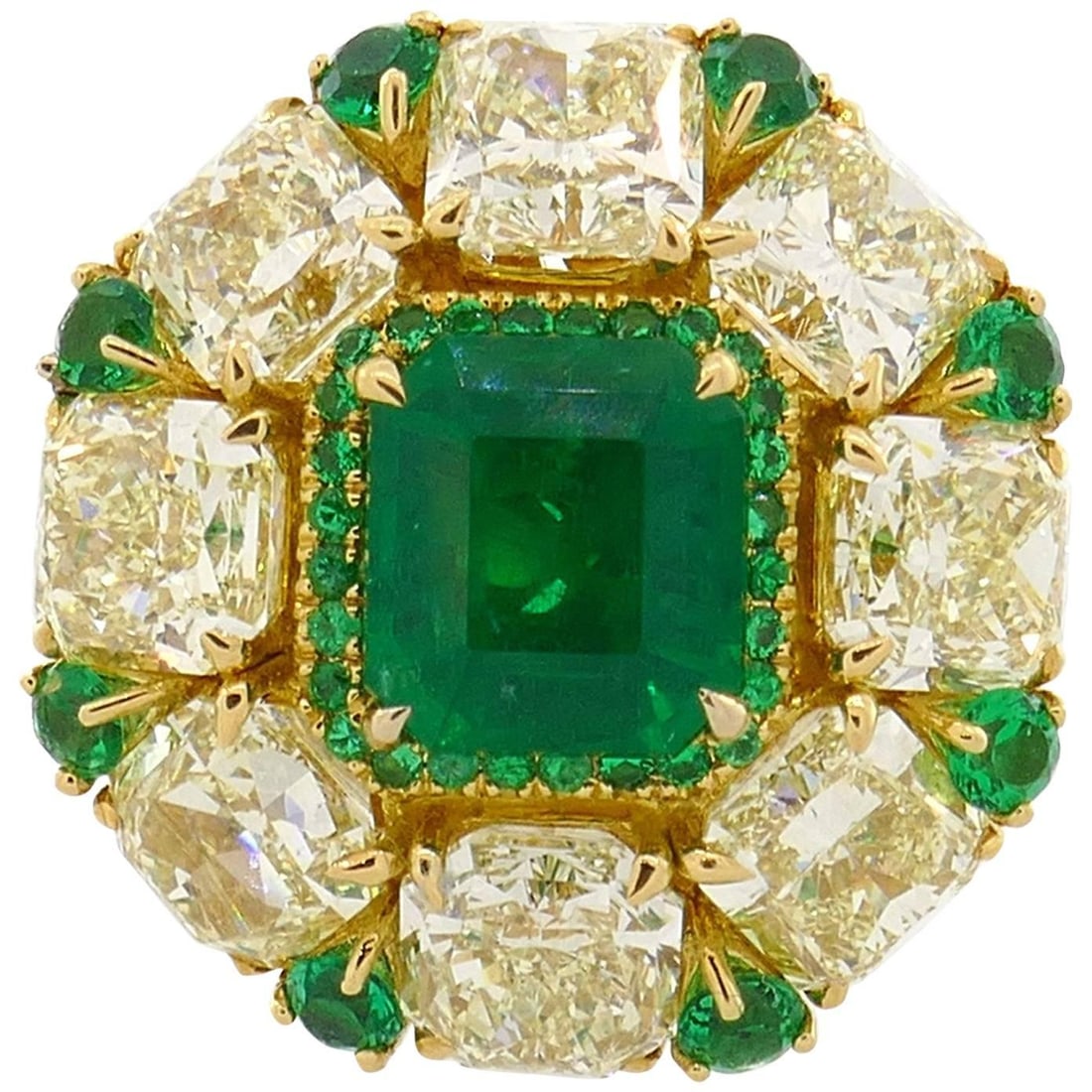 18k Yellow Gold Cocktail Ring with Emerald and Fancy Yellow Diamonds: 18k Yellow Gold Cocktail Ring with Emerald and Fancy Yellow Diamonds An 18k yellow gold cocktail ring featuring a 2.24-carat emerald framed by eight light fancy yellow radiant cut diamonds. The shank 