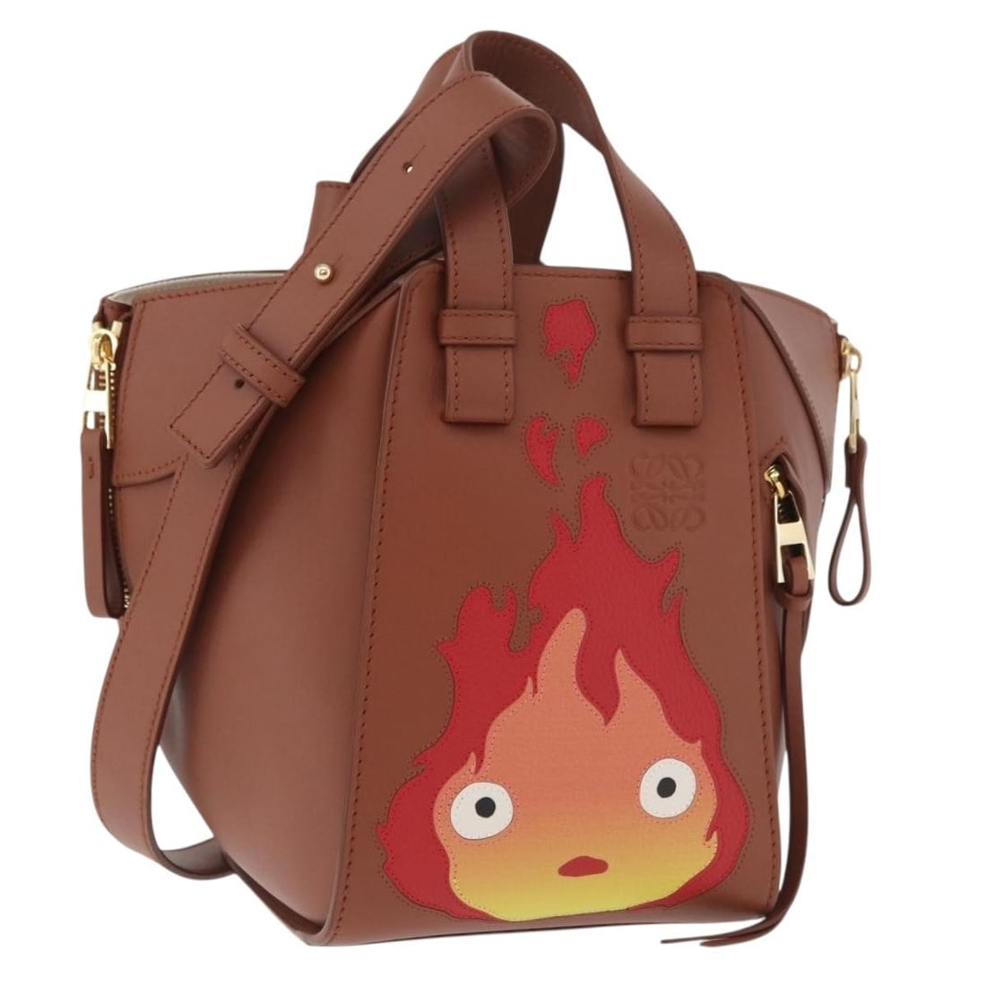 Howl's Moving Castle Calcifer Hammock Leather Bag by Loewe Ghibli Collaboration: Howl's Moving Castle Calcifer Hammock Leather Bag by Loewe Ghibli Collaboration This LOEWE x Studio Ghibli Howl's Moving Castle Hammock handbag features a two-way design crafted from brown and gold le