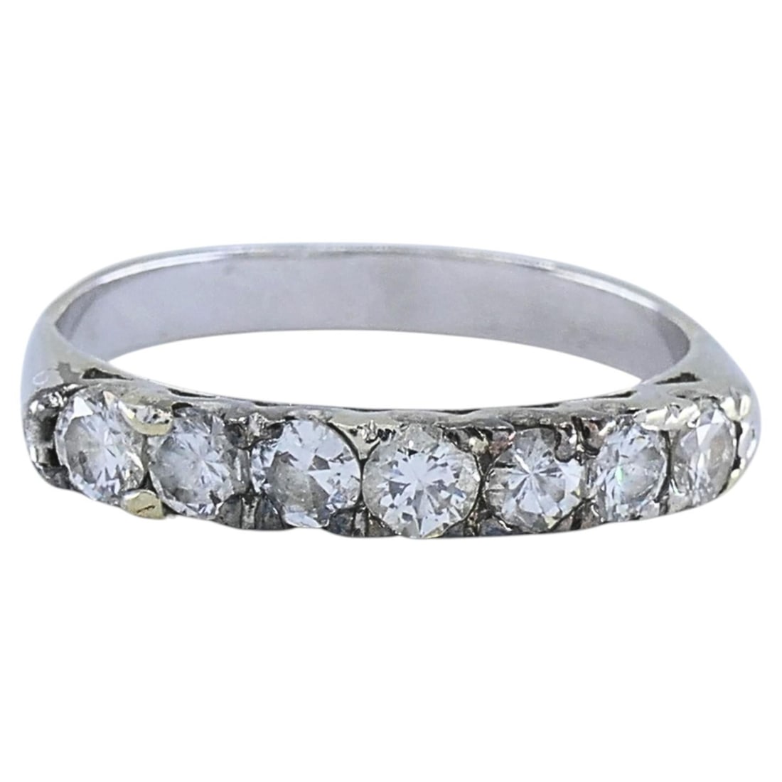 Vintage 12K White Gold 7 Stone Diamond Band Ring Size 5.25: Vintage 12K White Gold 7 Stone Diamond Band Ring Size 5.25 A vintage seven-stone diamond band ring in 12k white gold with a simple, classic design. The diamonds are set across the top of the band in p